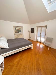 a bedroom with a large bed and a wooden floor at Casa di Gio in Malgrate