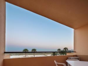 a large window in a room with a view of the ocean at Dom Pedro Lagos in Lagos