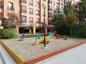 a playground in front of a building with playground equipment at Wanda IFEMA Aeropuerto Madrid JC in Madrid