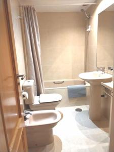 a bathroom with a toilet and a sink at Wanda IFEMA Aeropuerto Madrid JC in Madrid