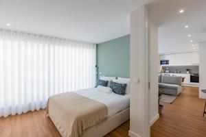 En eller flere senge i et værelse på Pestana Apartments - Premium