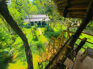 a view of a garden from the balcony of a house at Lucky Villa Sigiriya in Sigiriya