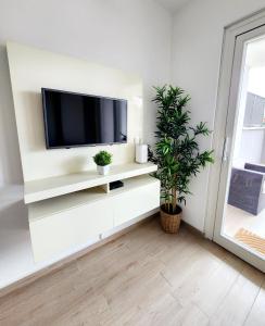 a living room with a flat screen tv on a white wall at Quela Apartment - Pietralata in Rome