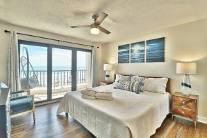 a bedroom with a bed and a large window at Direct Ocean Front 3BR 3BA Beach Front in Myrtle Beach