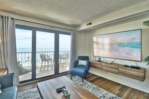 a living room with a large window with a view of the ocean at Direct Ocean Front 3BR 3BA Beach Front in Myrtle Beach