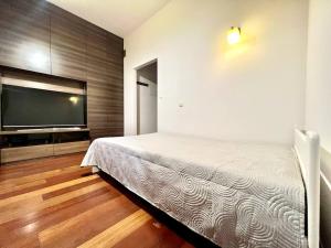 a bedroom with a bed and a flat screen tv at K22 Filtrowa Apart Warsaw in Warsaw