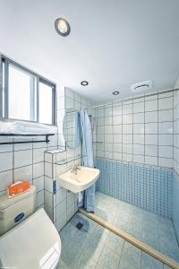 a bathroom with a toilet and a sink at 亞馨文旅 YesHome Hotel in Hualien City