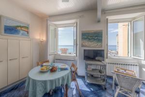 a dining room with a table and a view of the ocean at Beach House Camogli in Camogli