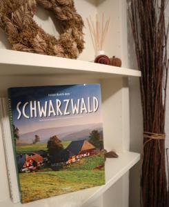 a book on a shelf with a sign that reads quarantine at Haus Schwedes in Titisee-Neustadt