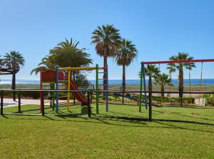 a playground at the beach with palm trees at Dom Pedro Lagos in Lagos