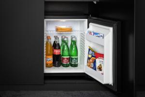 an open refrigerator filled with soda and drinks at Ponton Rooms in Bratislava