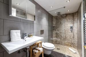 a bathroom with a sink and a toilet and a shower at Historic 18th Century Terrace House in London