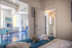 a bedroom with a bed and a room with a table at Beach House Camogli in Camogli