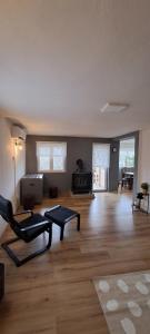 an empty living room with a chair and a table at House Anita in Grabovac