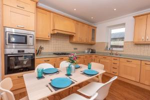 a kitchen with a table with blue plates on it at Dudley House in Woolacombe