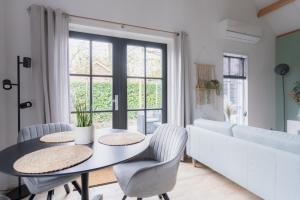 een woonkamer met een tafel en een bank bij Vakantiehuis De Zeearend Dishoek in Dishoek