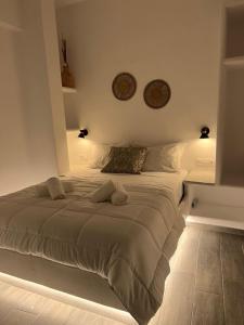 a bedroom with a large bed with two pillows at Juli’s Suites in Mérikhas