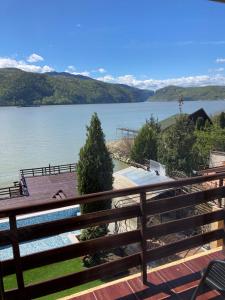a view from the deck of a house overlooking a lake at Pension La Ponton in Eşelniţa