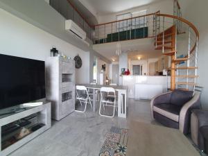 a large living room with a kitchen and a living room at Etoile d'Azur in Sainte-Maxime