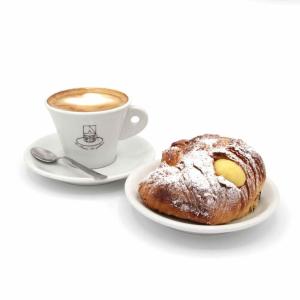 a cup of coffee and a pastry on a plate at MaLù BEST Rooms - Tropea in Tropea