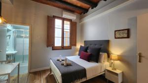 a bedroom with a bed and a window and a bathroom at Barrio Gotico Apartments Ferran in Barcelona