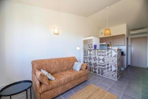 a living room with a couch and a table at Résidence Santa Monica in Bonifacio