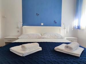 a bedroom with two towels on a bed at Art of Zadar- rooms and apartment in Zadar +33 photos
