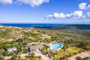 an aerial view of a resort with a swimming pool and the ocean at Résidence Santa Monica in Bonifacio