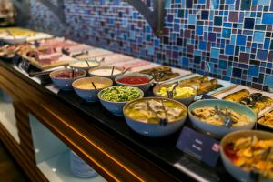 a buffet with many bowls of food on a table at Sheraton Sopot Hotel in Sopot