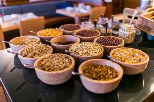 a table topped with bowls of different types of food at Sheraton Sopot Hotel in Sopot