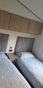 two beds sitting next to each other in a bedroom at Boulevard in Selsey