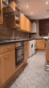 a large kitchen with a washer and dryer in it at London Property Apartments for up to 6, next to Big Ben & London Eye in London