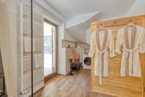 a room with a sliding door with robe at Resort Stari Malni in Osilnica