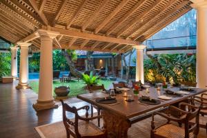 a dining room with a wooden table and chairs at Taru Villas Rampart Street - Galle Fort in Galle