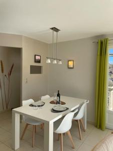 a dining room with a white table and chairs at Salvezines Villa in Salvezines +20 photos