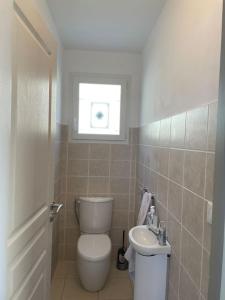 a small bathroom with a toilet and a sink at Salvezines Villa in Salvezines