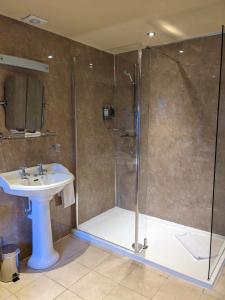 a bathroom with a shower and a sink at Dalhousie Castle Hotel in Bonnyrigg