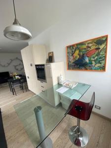 - un salon avec une table et une chaise rouge dans l'établissement Maison Minù, à Porto Ceresio