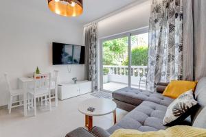 a living room with a couch and a table at Two bedroom apartment near the ocean in Playa de las Americas