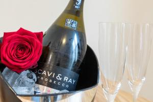 a bottle of champagne with a red rose in a bucket at Hubertus Hof in Goslar