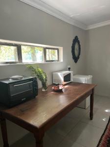 a wooden table with a microwave on top of it at Dennegeur Guesthouse in Somerset East