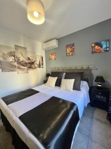 a large bed in a room with paintings on the wall at DIEGO 4 pièces duplex in Nice