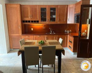 a kitchen with a table and chairs in a kitchen at Azor International House in Ponta Delgada