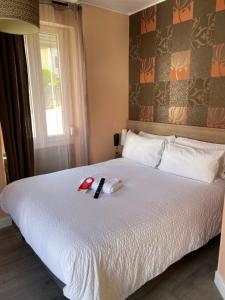Postel nebo postele na pokoji v ubytování Hôtel Oxo