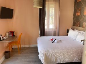 Postel nebo postele na pokoji v ubytování Hôtel Oxo