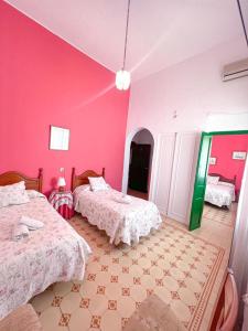 Postel nebo postele na pokoji v ubytování Hostal El Faro
