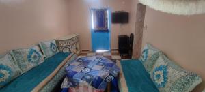 a room with a couch and a bed and a television at Mehdi House in Chefchaouen