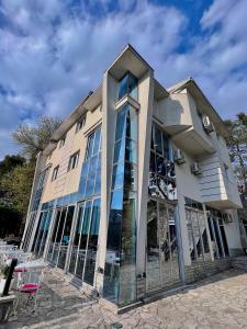 a building with glass windows on the side of it at Hotel Ambasador in Podgorica