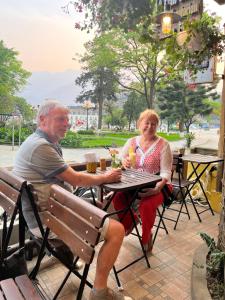 un hombre y una mujer sentados en una mesa en Le Petit Gecko Hotel en Sa Pa