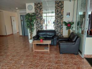 a lobby with two leather chairs and a coffee table at Canada Hotel Budapest in Budapest